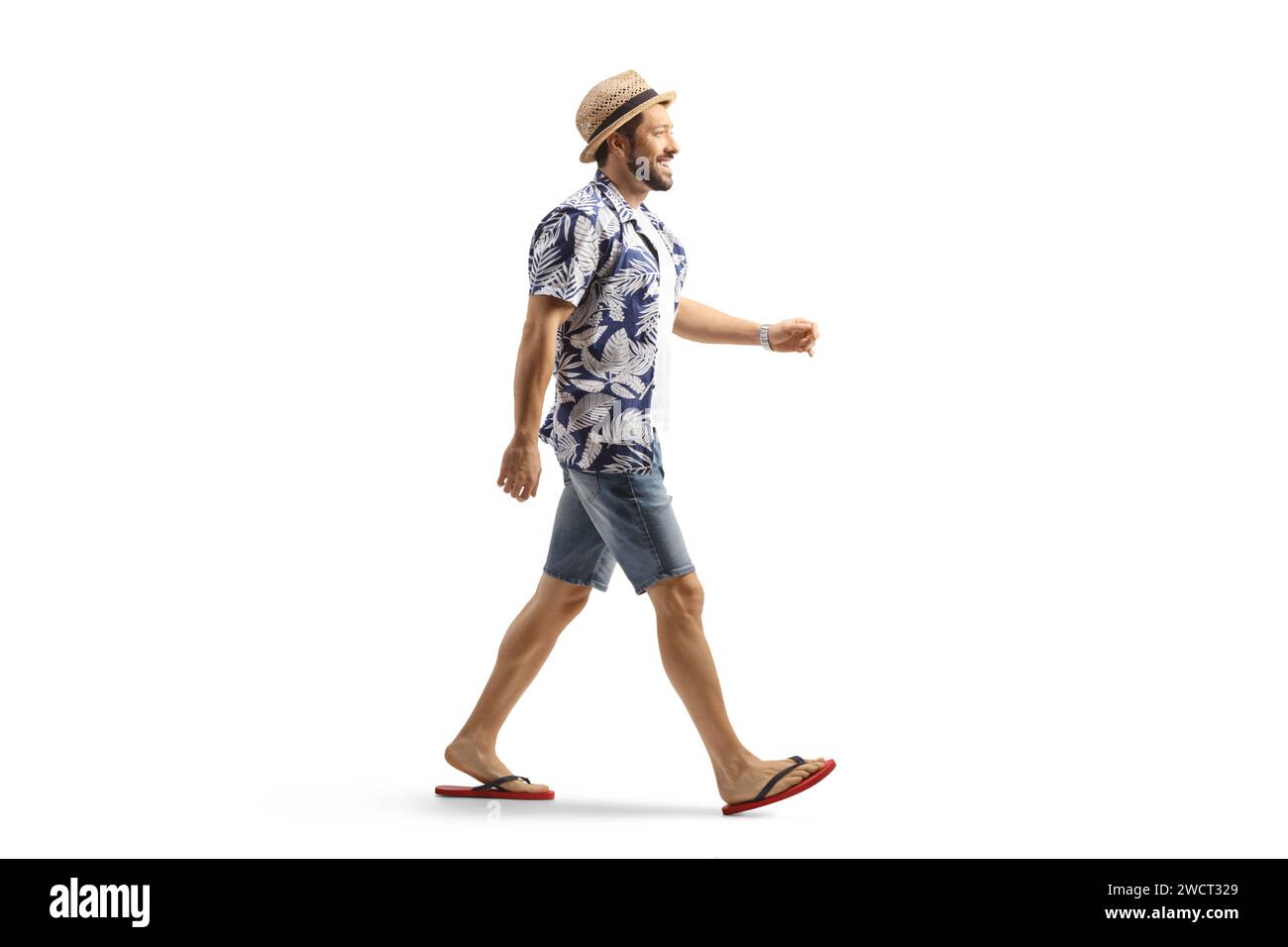 Full length profile shot of a man in flip-flops and straw hat walking isolated on white background Stock Photo