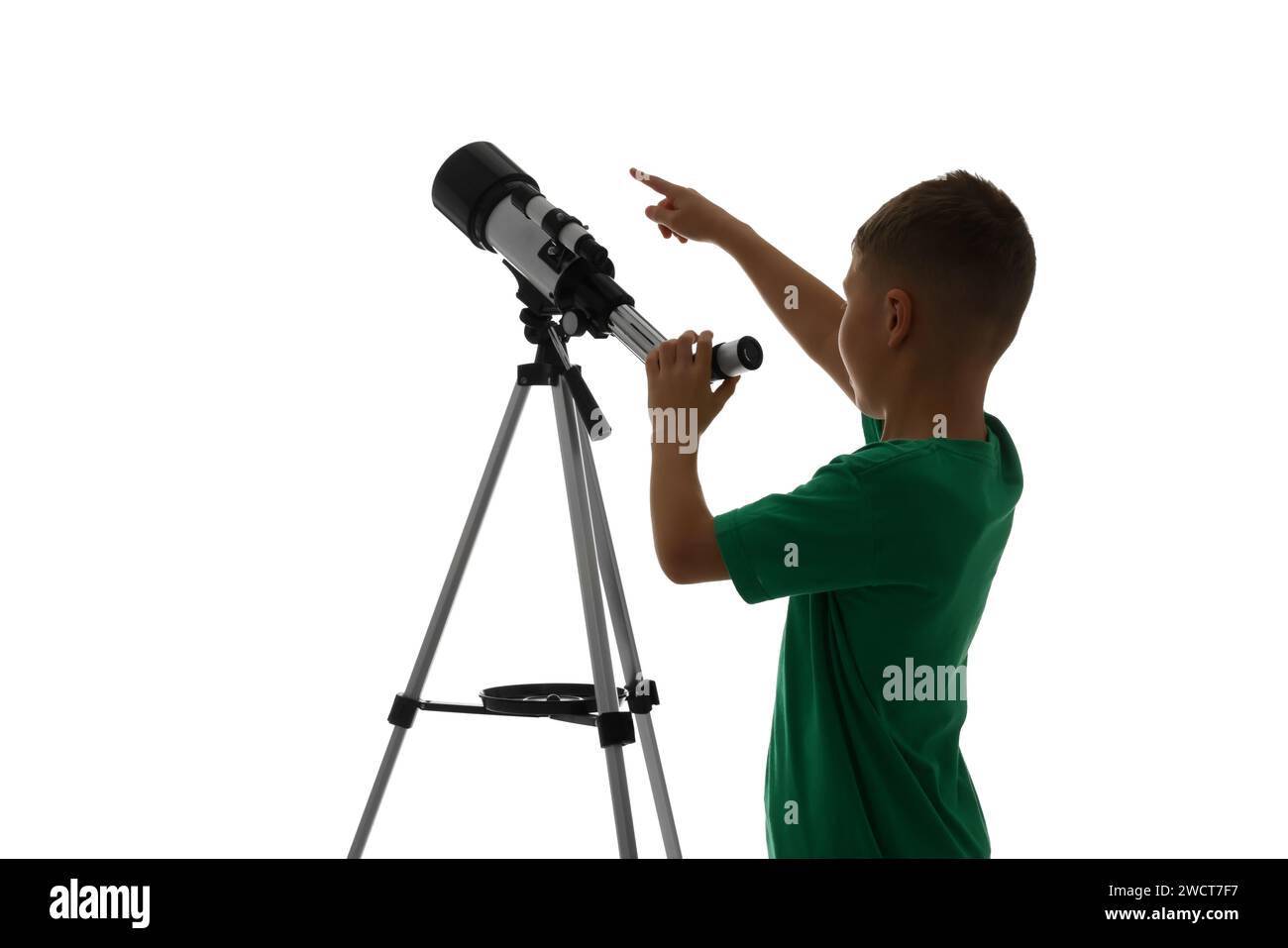 Little boy with telescope pointing at something on white background Stock Photo