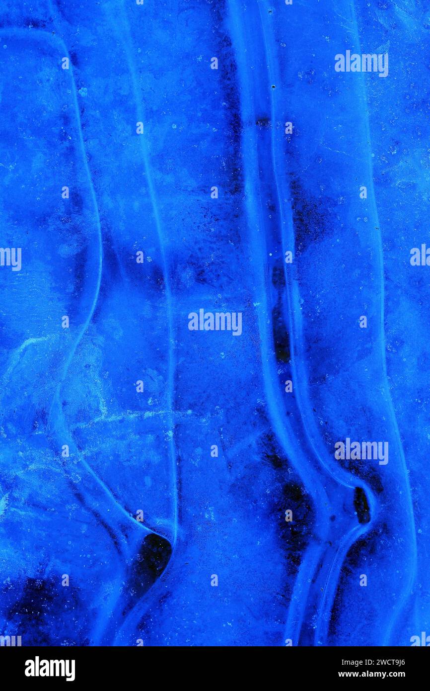 Close up deep blue grooves in ice, flowing like a river, capturing the ...