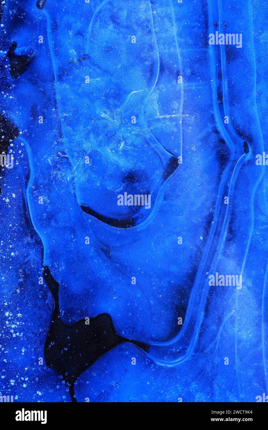 Close up deep blue grooves in ice, flowing like a river, capturing the ...