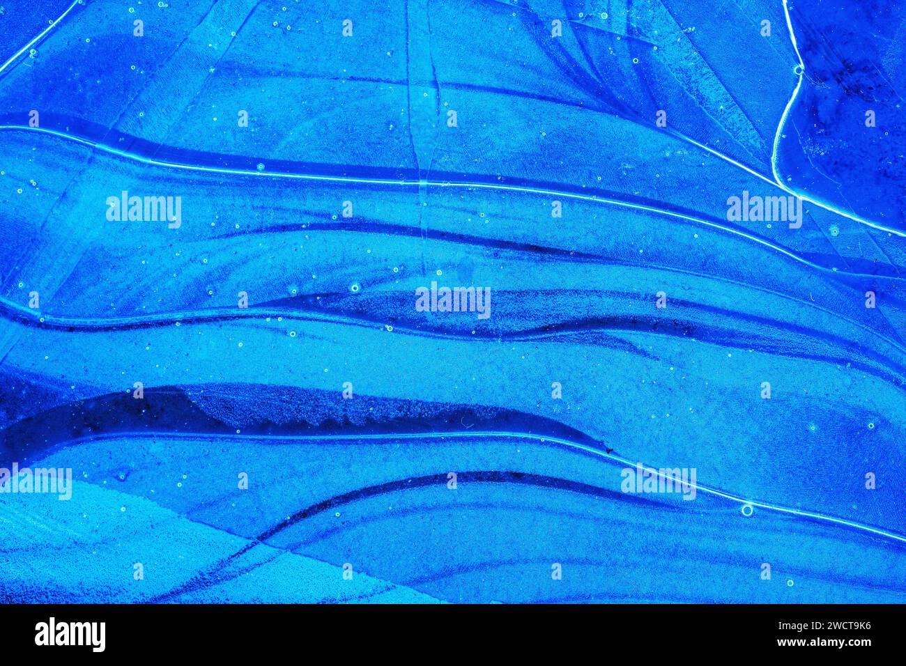 Close up deep blue grooves in ice, flowing like a river, capturing the ...