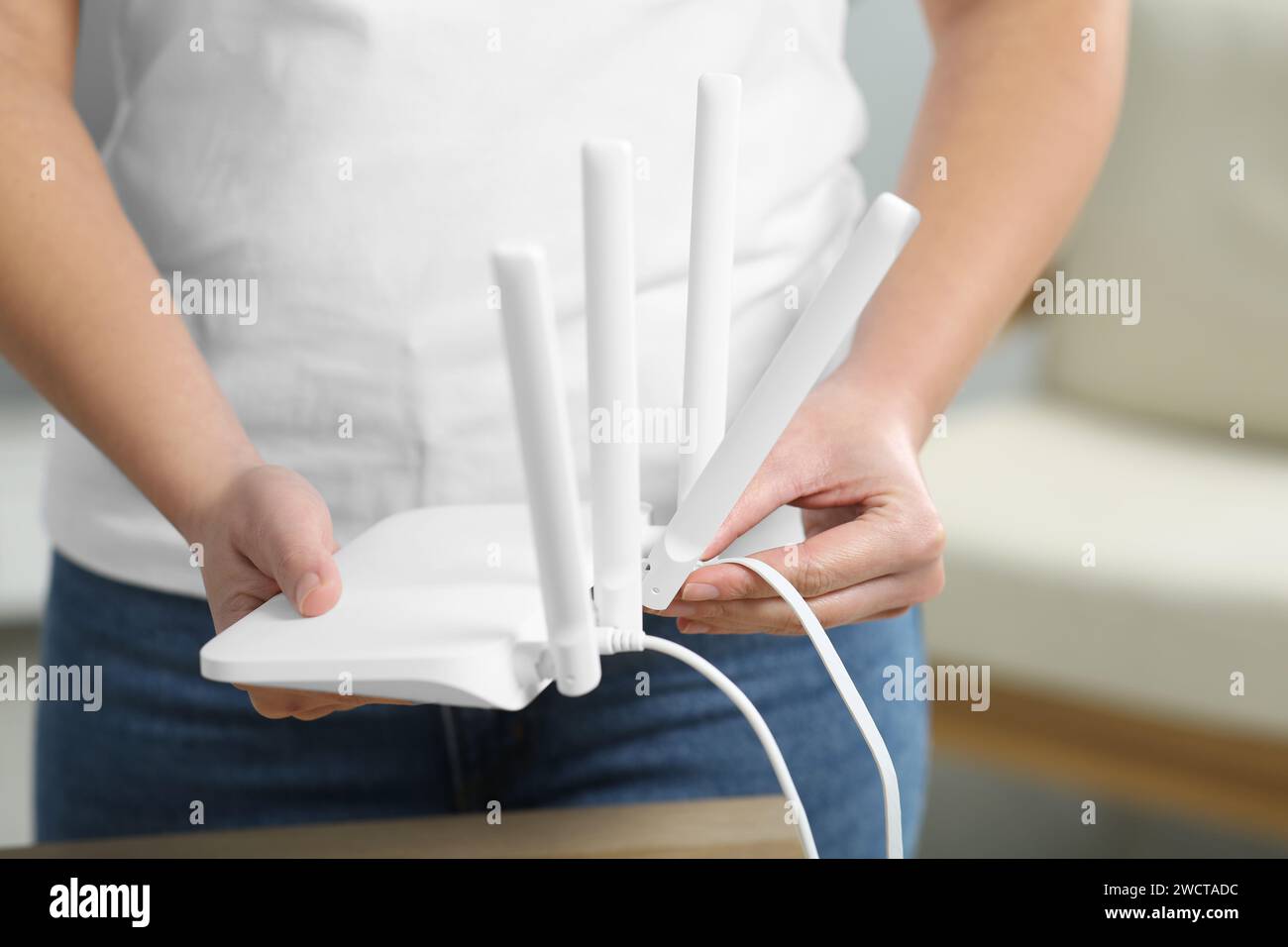 Hands ethernet cable router hi-res stock photography and images - Alamy