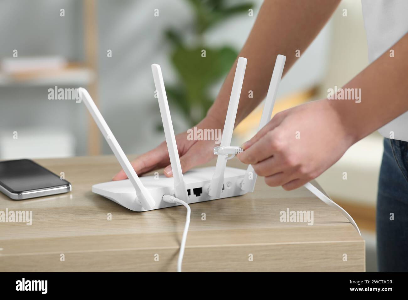 Hands ethernet cable router hi-res stock photography and images - Alamy