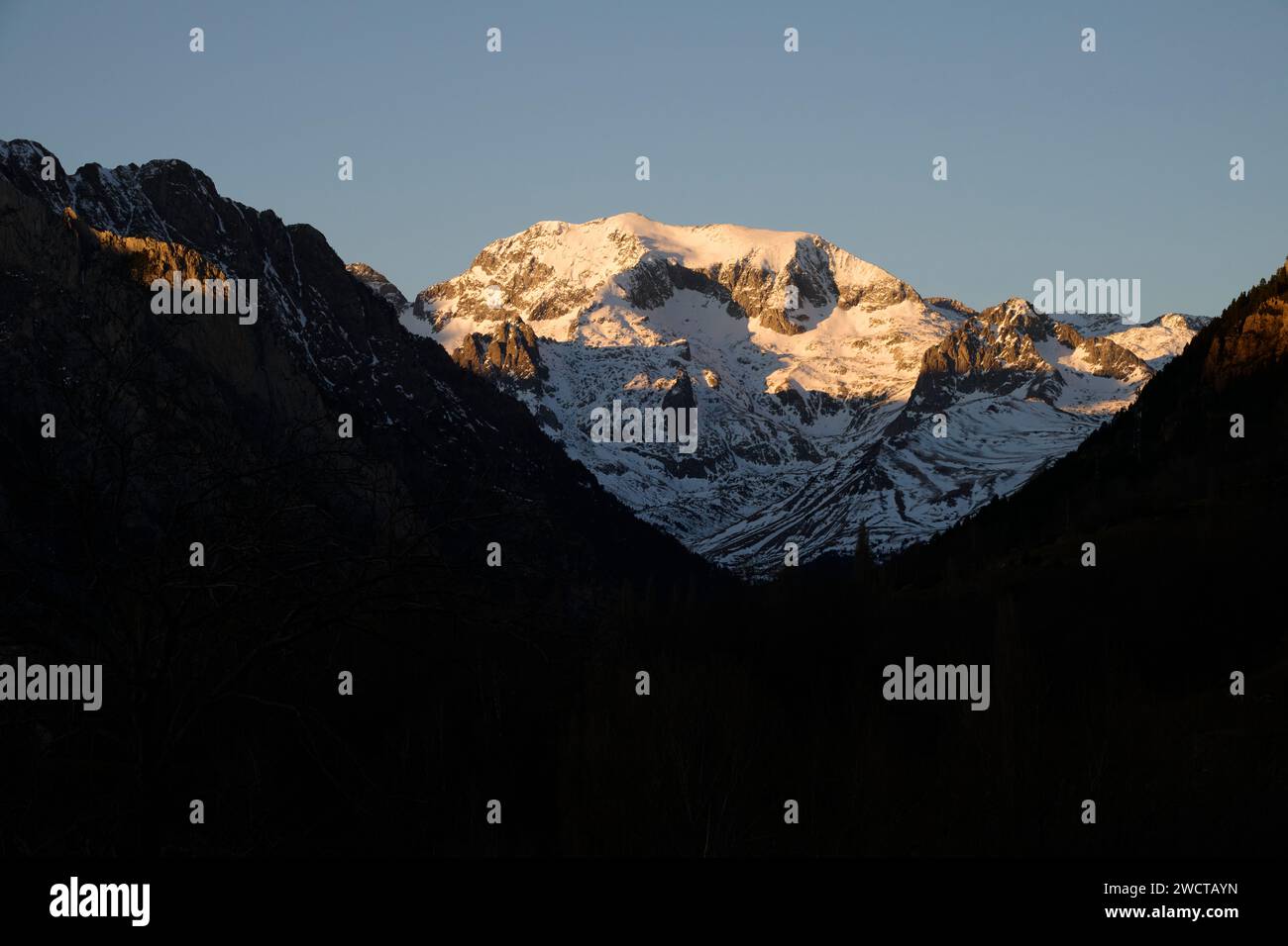The golden hour illuminates a majestic snow-capped mountain ...