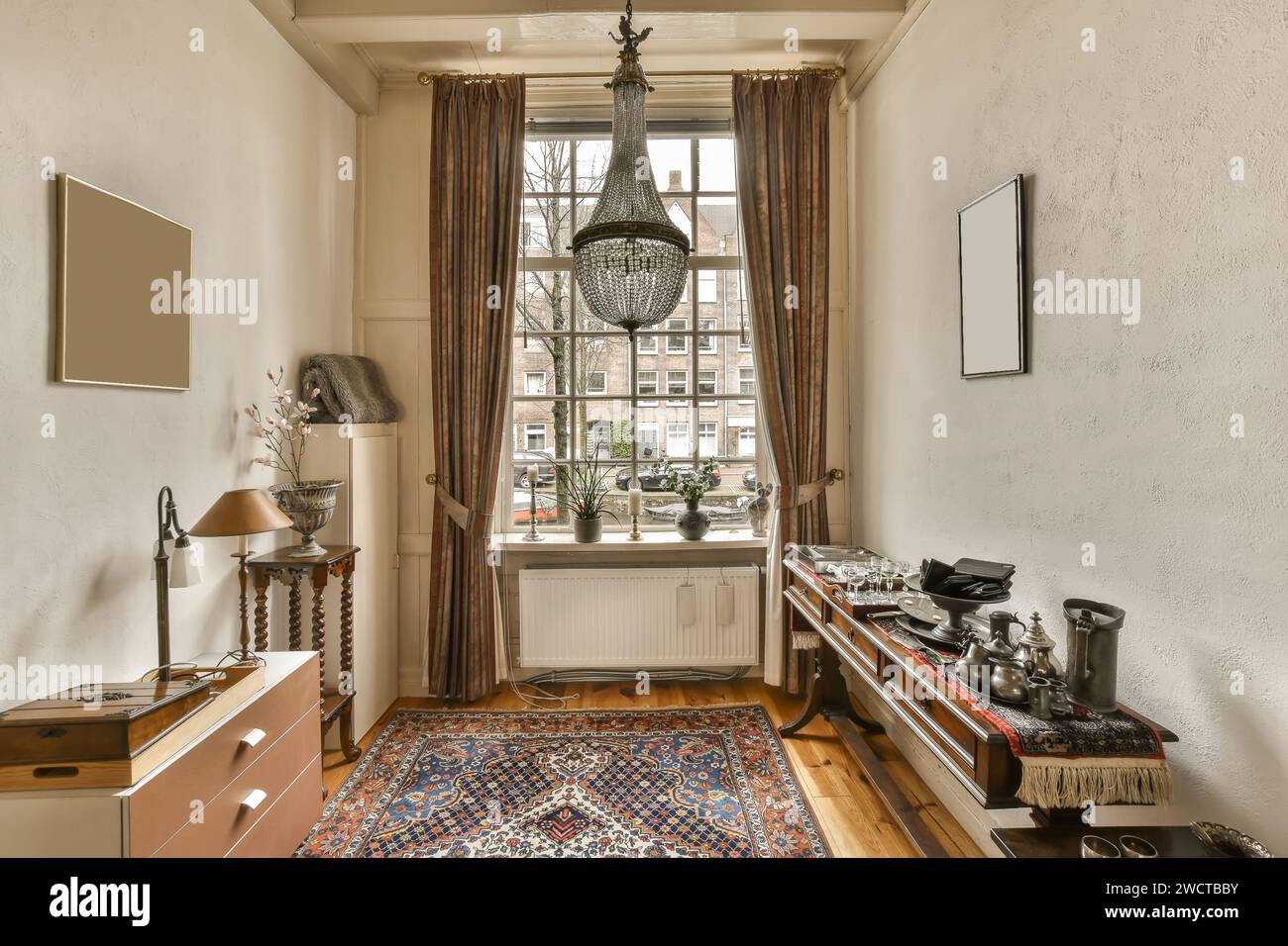 Elegant vintagestyle room featuring a chandelier, framed artworks, and