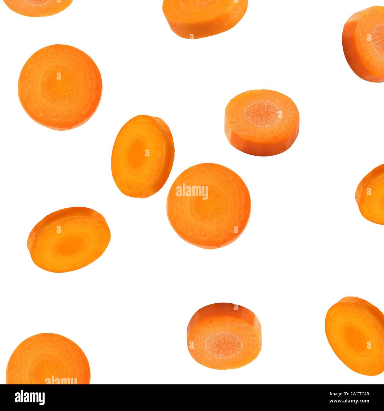Fresh carrot slices falling on white background Stock Photo