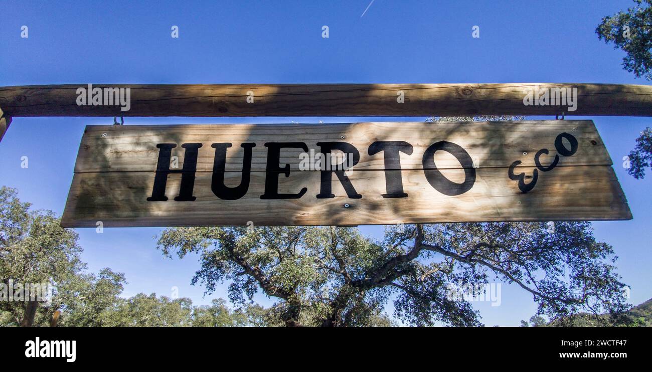 Organic kitchen garden hanging sign at mediterranean background. Spanish language letters Stock Photo