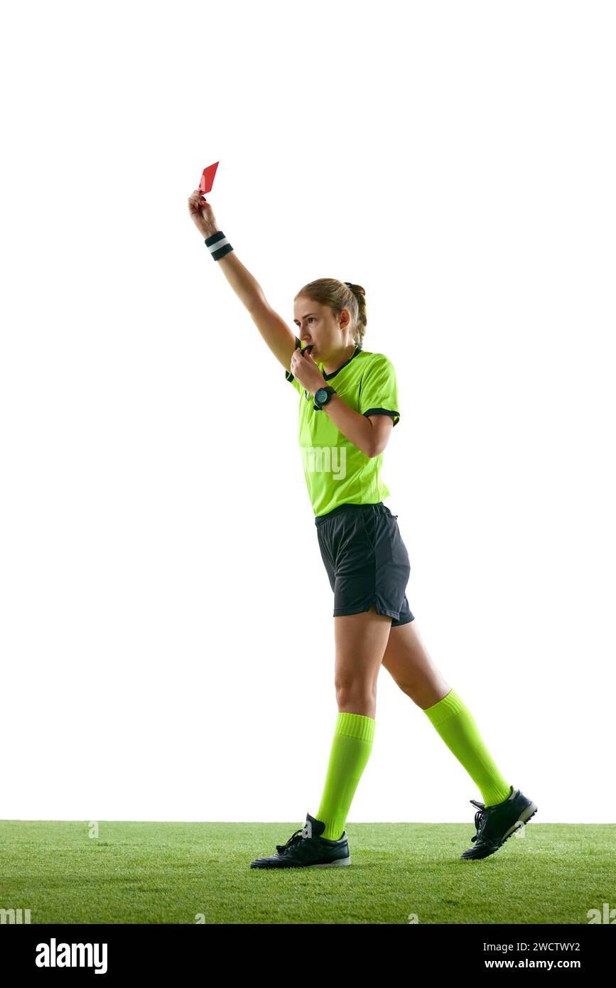 Serious woman, soccer referee gesturing, raising hand, stopping game and showing red card