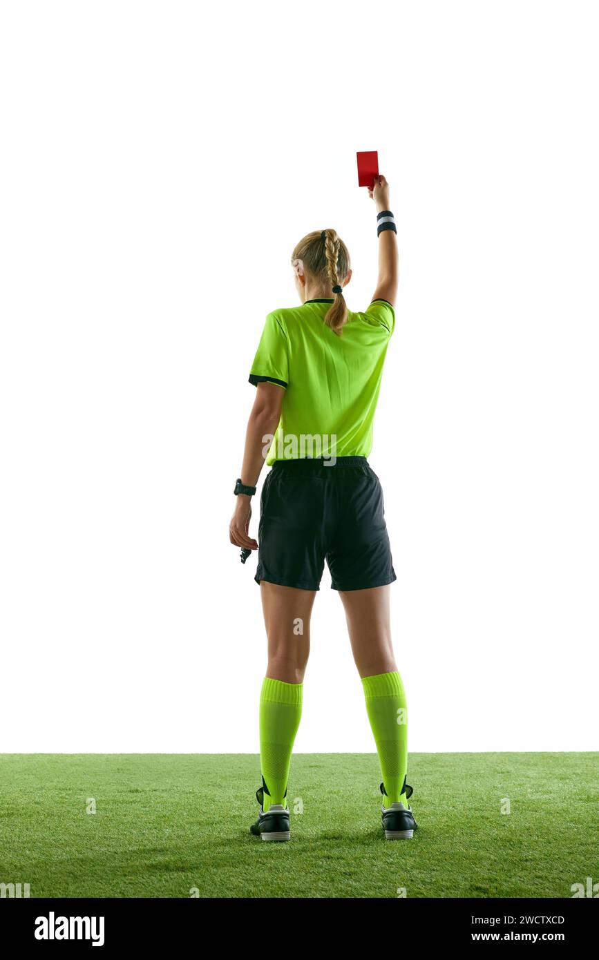 Serious woman, soccer referee gesturing, raising hand, stopping game and showing red card