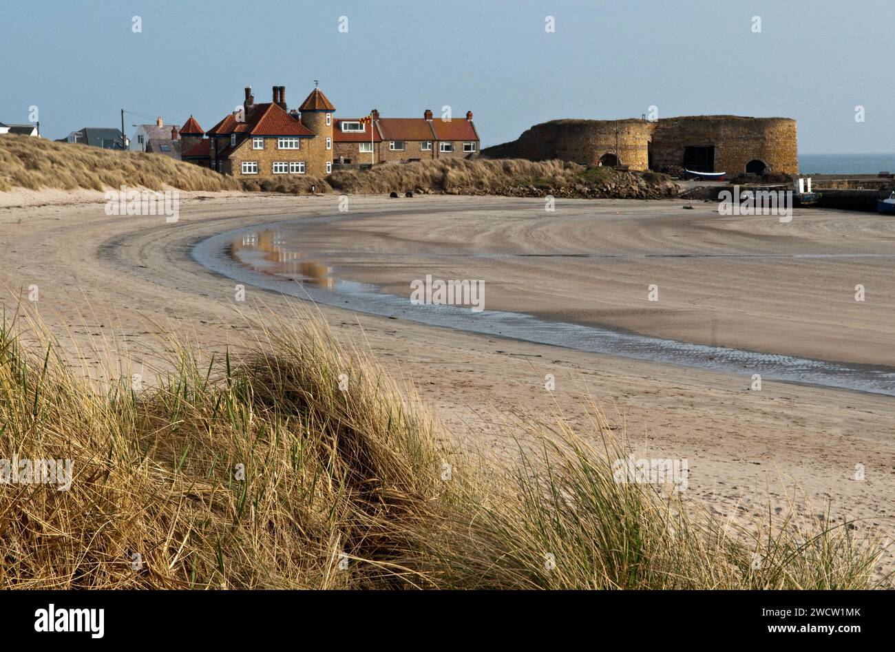 Beadnell and Beadnell Beach on the Northumberland Coast in March showing houses, limekilns and the harbour Stock Photo