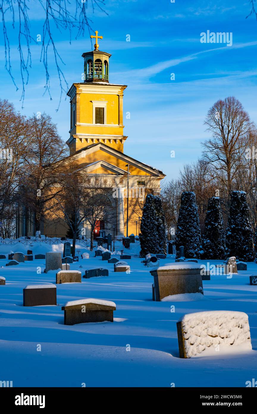 Graveyard covered in snow and Kumla church Stock Photo