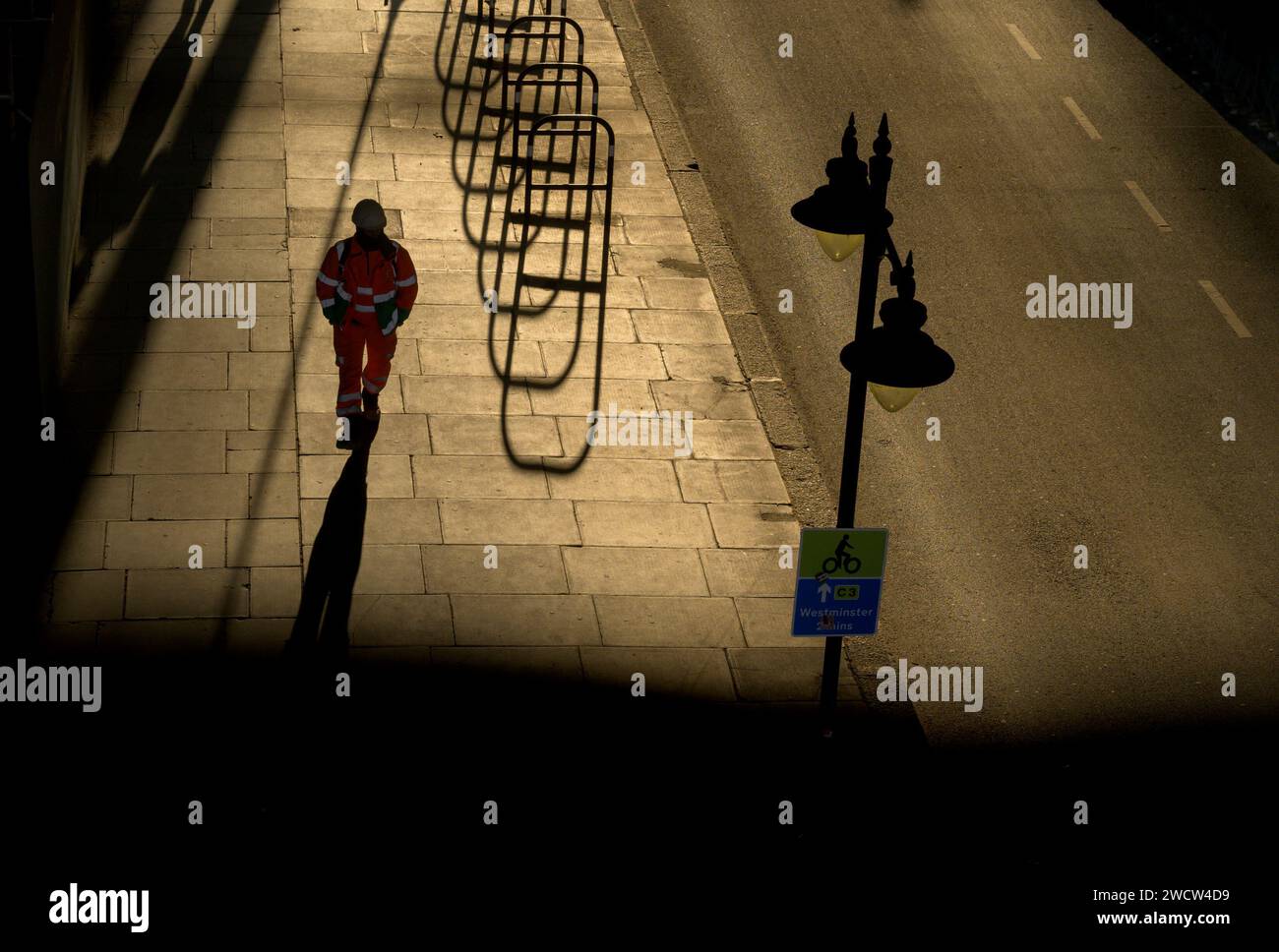London, UK. Shadows under Waterloo Bridge in the evening - people and cycle racks Stock Photo