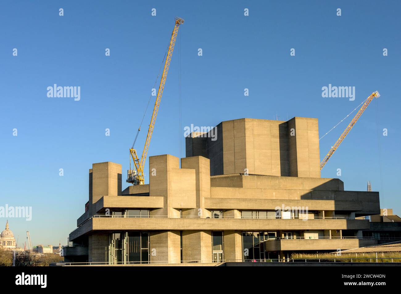 London, UK. Royal National Theatre on the South Bank, with construction cranes behind. Stock Photo