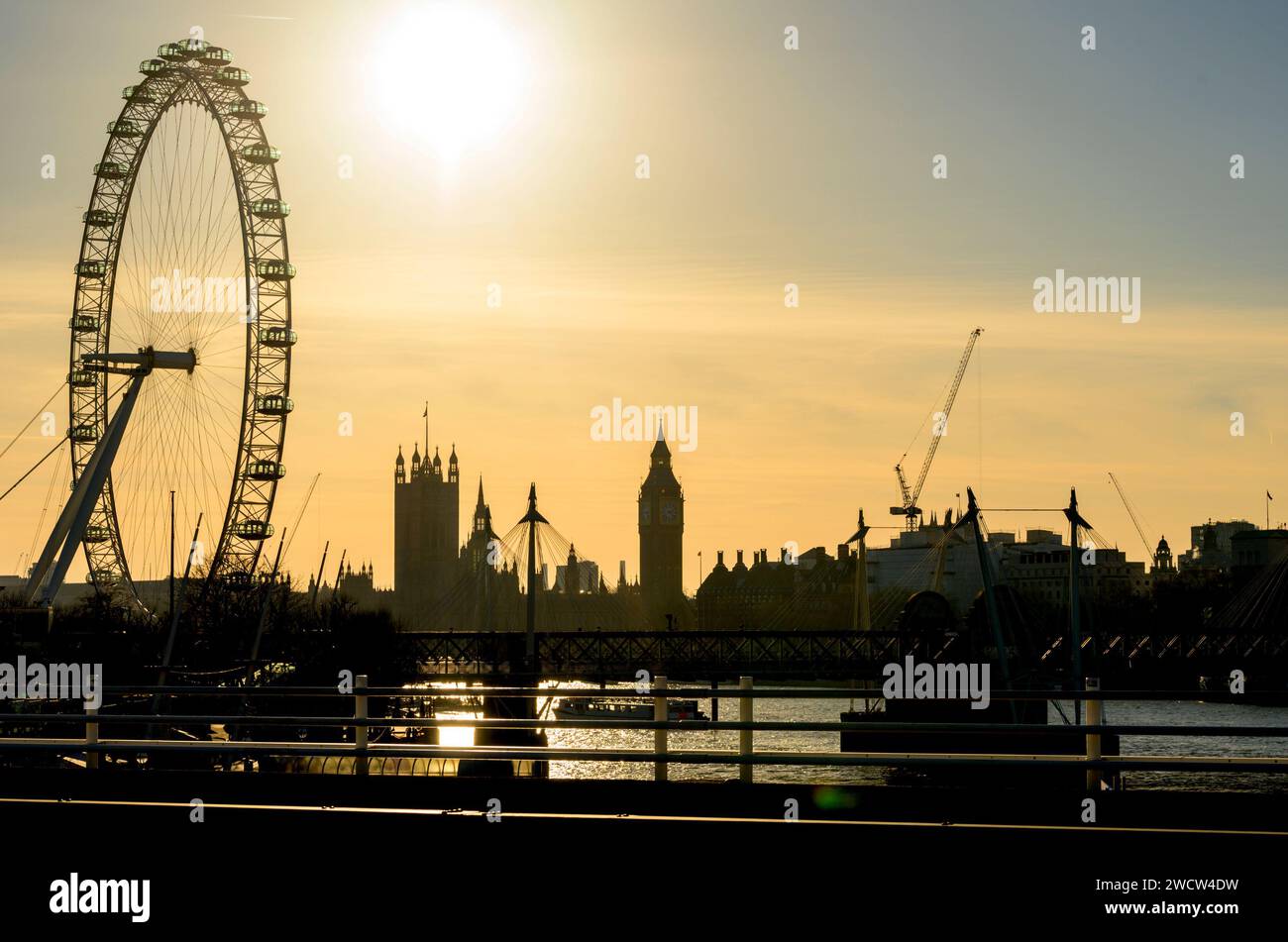 London, UK. Early evening view of Westminster from Waterloo Bridge. London Eye and the Houses of Parliament Stock Photo