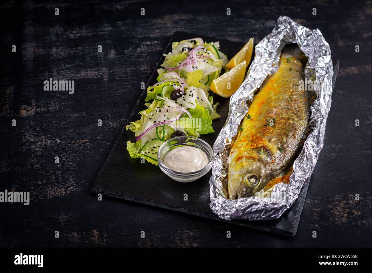 Baked sea bass and green salad. Healthy eating. Keto, ketogenic diet