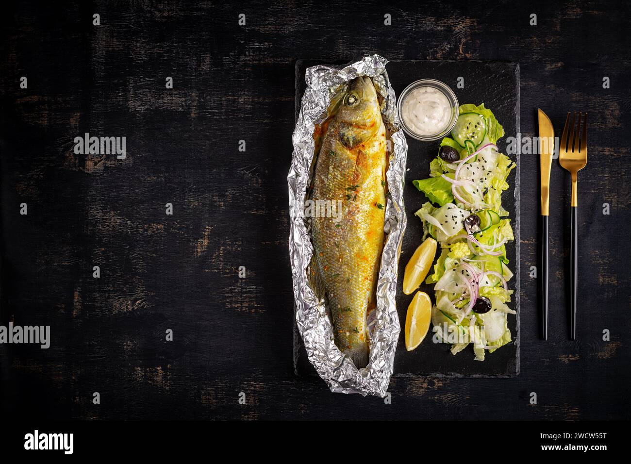 Baked sea bass and green salad. Healthy eating. Keto, ketogenic diet
