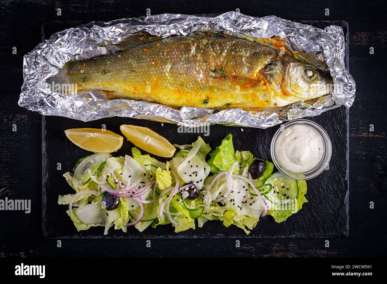 Baked sea bass and green salad. Healthy eating. Keto, ketogenic diet
