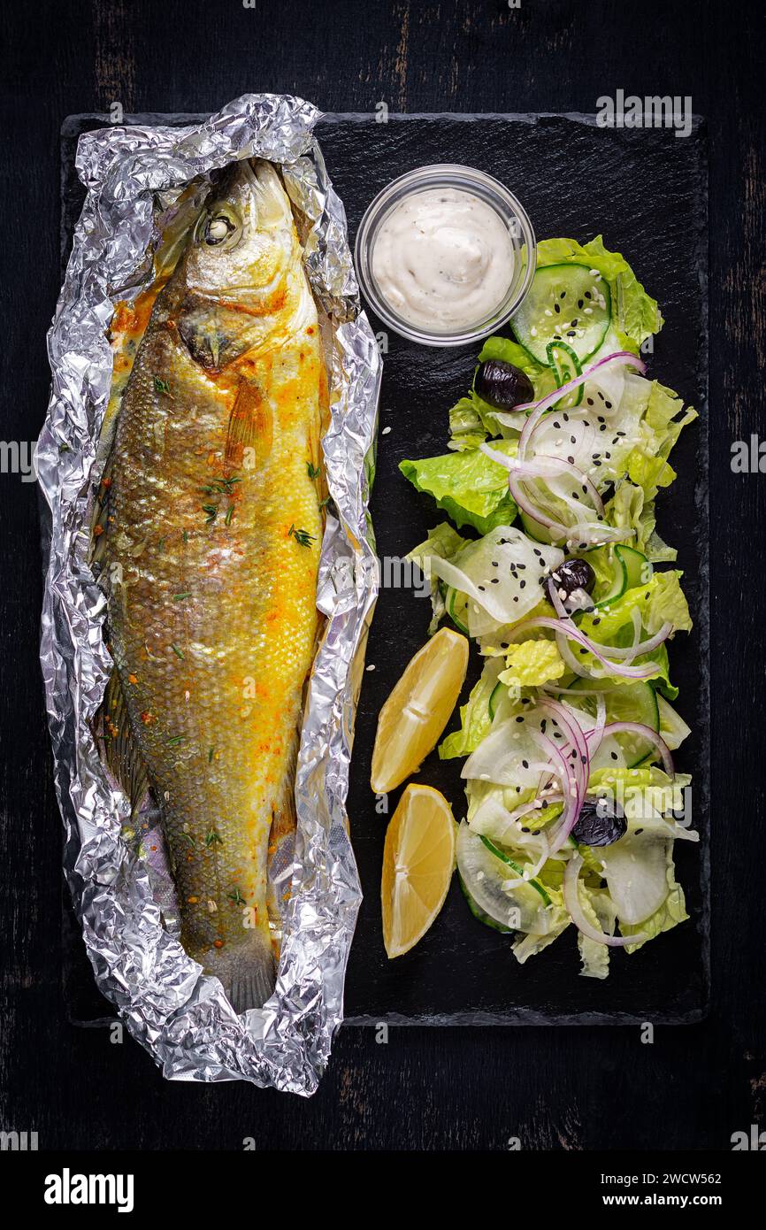 Baked sea bass and green salad. Healthy eating. Keto, ketogenic diet