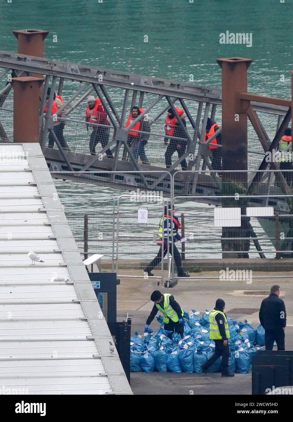 A group of people thought to be migrants are brought in to Dover, Kent, from a Border Force vessel following a small boat incident in the Channel. Picture date: Wednesday January 17, 2024. Stock Photo