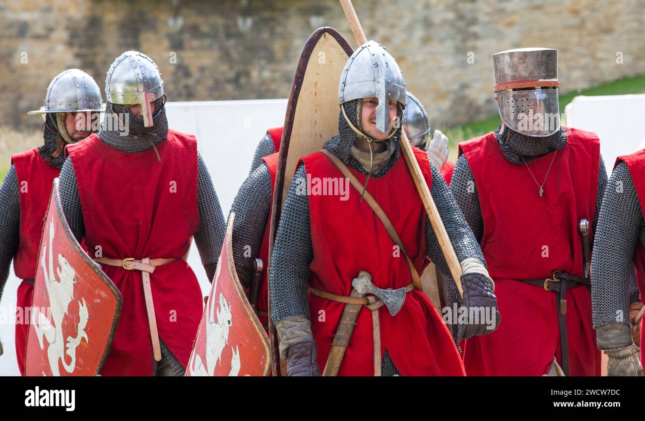 Lincoln, Lincolnshire, England. Warriors on the march prior to taking part in a medieval battle re-enactment in the grounds of Lincoln Castle. Stock Photo