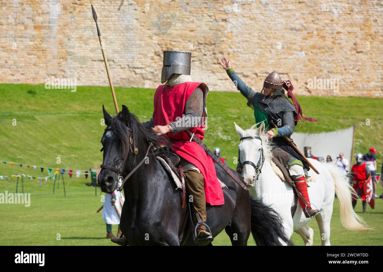 Lincoln, Lincolnshire, England. Mounted warriors taking part in a medieval battle re-enactment on the lawns of Lincoln Castle. Stock Photo