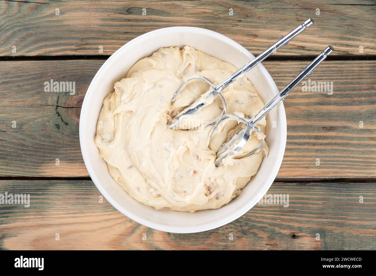 Top view of the mixed dough for making a cake and the mixer attachment