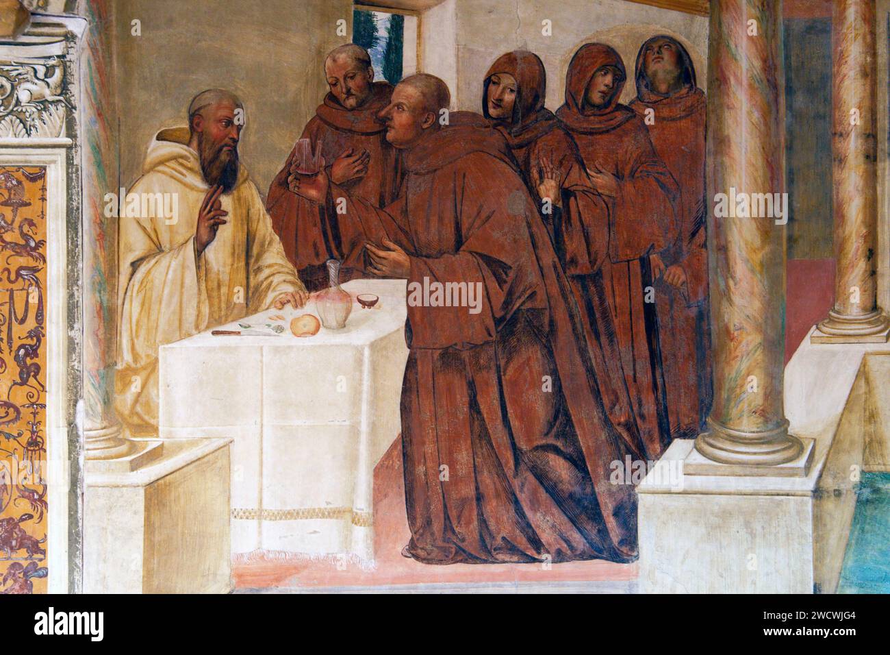 Italy, Tuscany, Siena countryside, Crete Senesi, town of Asciano, Chiusure, Monte Oliveto Maggiore Benedictine Abbey (Abbazia di Monte Oliveto Maggiore), the cloister, San Benedetto life fresco by Signorelli and Sodoma, like Benedict breaks a glass of poisoned wine with the sign of the cross Stock Photo