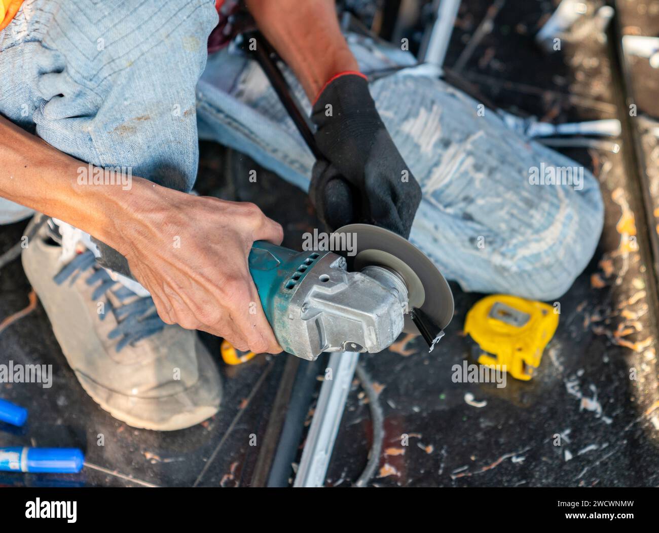 Building contractor is cutting lightweight metal, steel, edge trim with