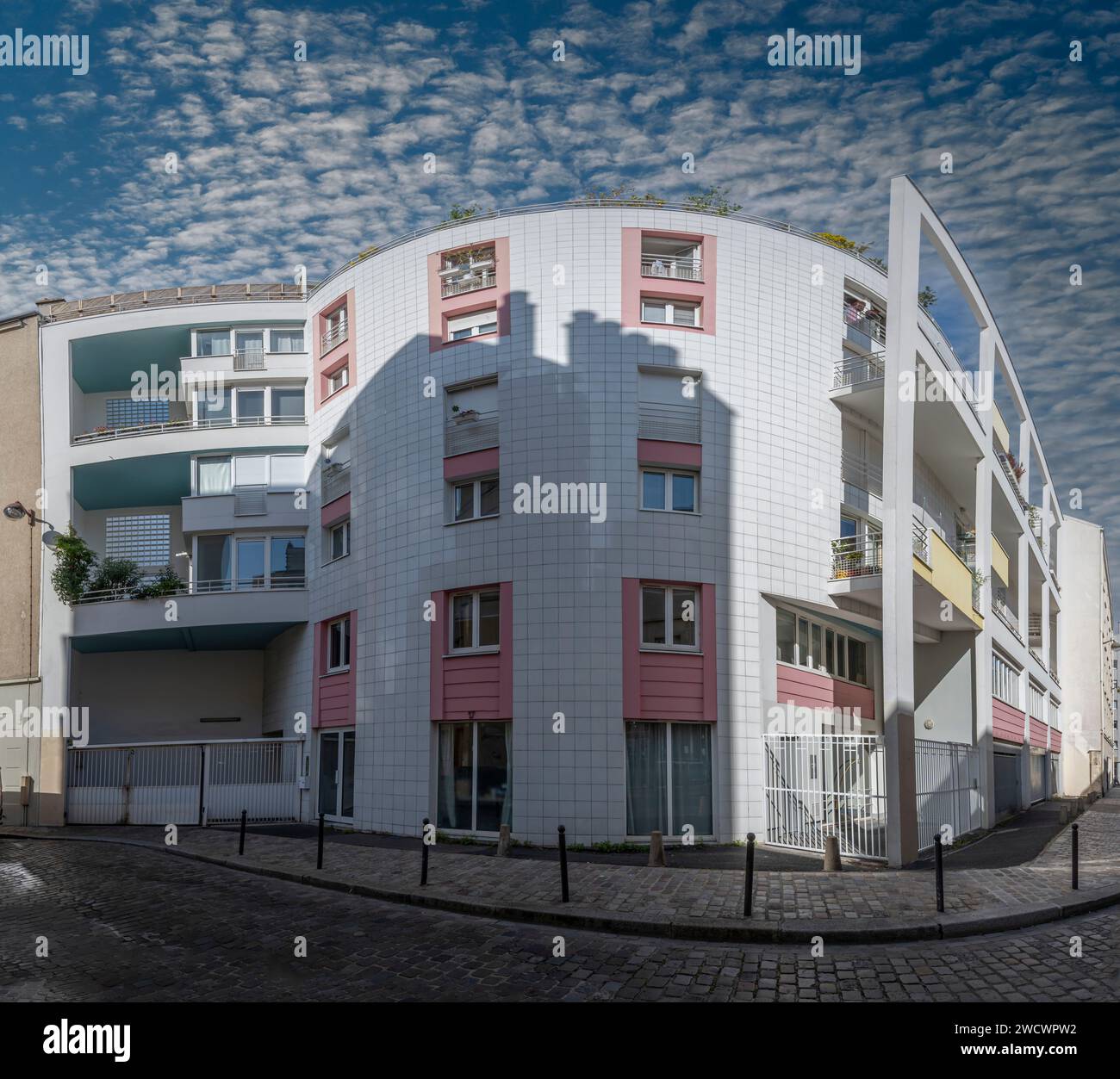Paris, France - 09 23 2023: View of a modern white and pink facade of a ...