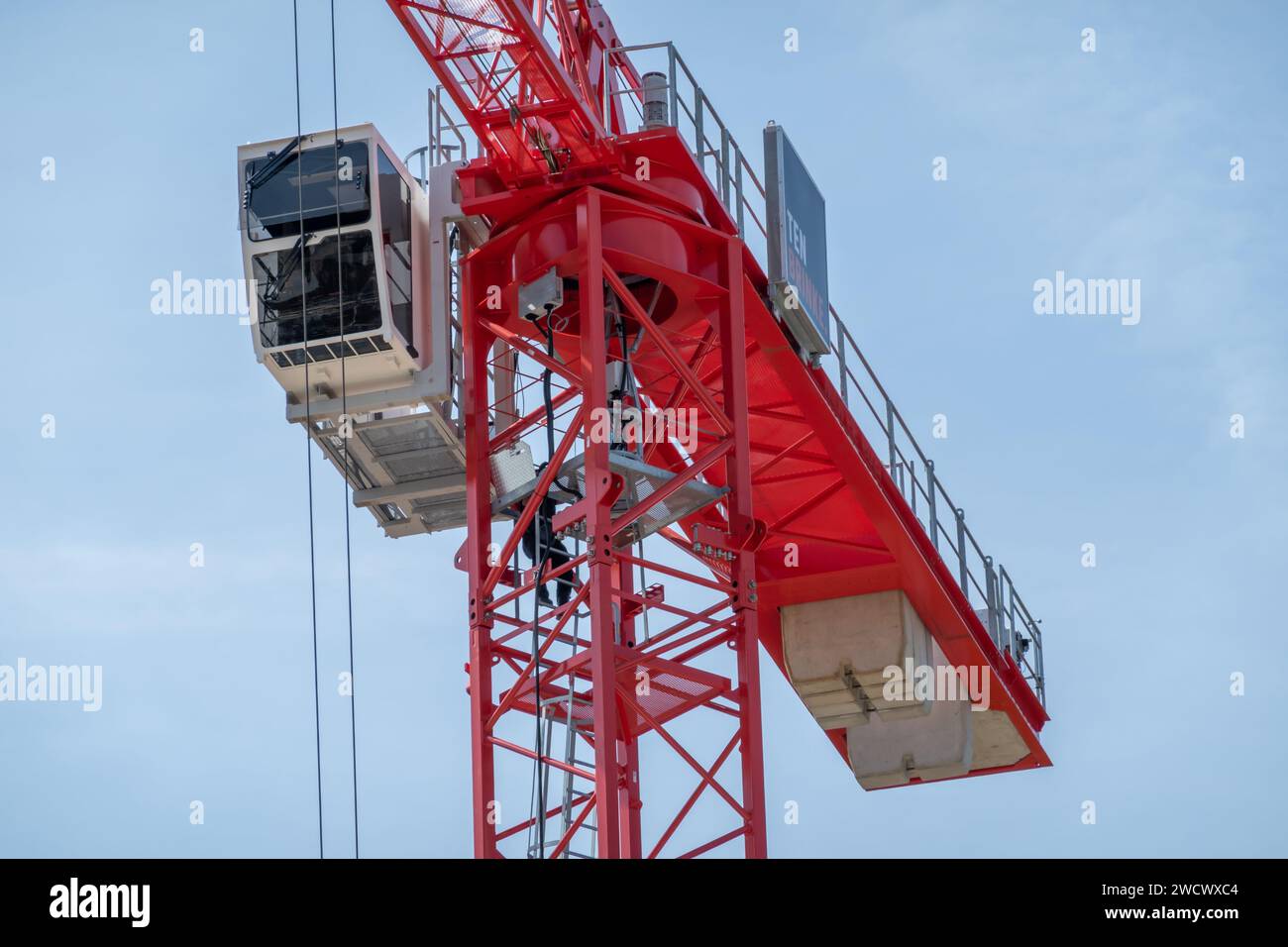 Detail of red tower crane with telescopic boom, stairs and cabin for workers, Netherlands Stock Photo