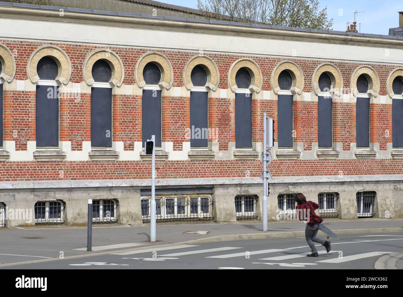 France, Nord, Dunkirk, pedestrian crossing in front of the former Bains Dunkerquois (1896) in Moorish style according to plans by architects Louis Gilquin, Charles Boidin and Albert Baert with swimming pool, wash houses, bathtubs... Stock Photo