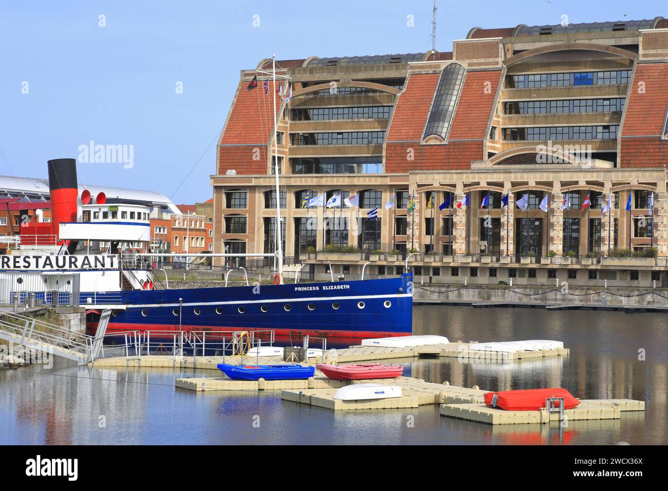 France, Nord, Dunkirk, navy basin, Dunes de Flandre sailing school and the Princess Elizabeth restaurant (paddle steamer from 1927 which participated in Operation Dynamo in 1940) with the building of the Urban Community of Dunkirk in the background Stock Photo