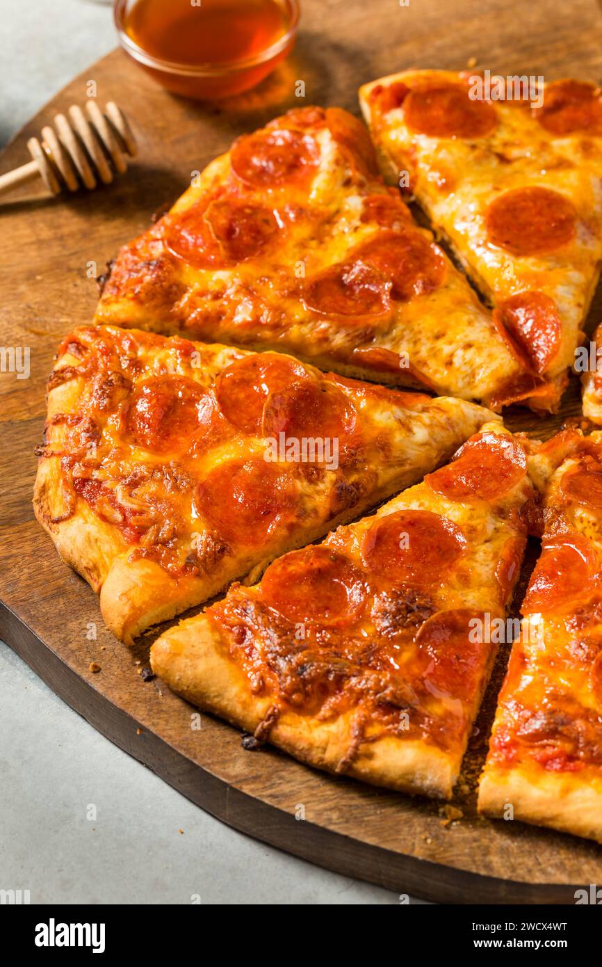 Homemade Spicy Hot Honey Pepperoni Pizza with Cheese and Sauce Stock