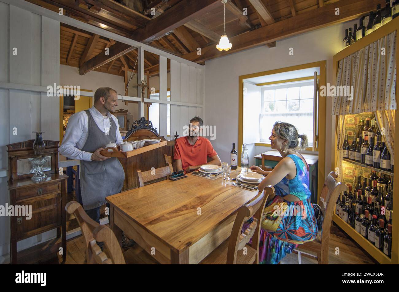 Portugal, Azores archipelago, Terceira island, couple seated in the rustic decor of the restaurant of the quinta do martelo, an old farm transformed into a rural ecotourism complex Stock Photo