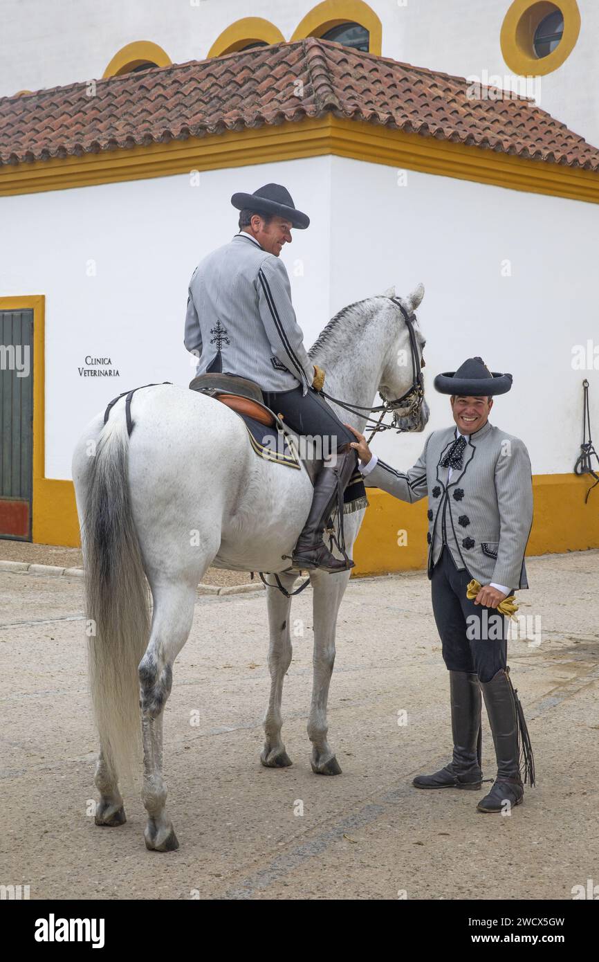 Spain, Andalusia, Jerez de la Frontera, Andalusian royal school of equestrian art, rider in Goyesque costume on a white horse in the stables Stock Photo