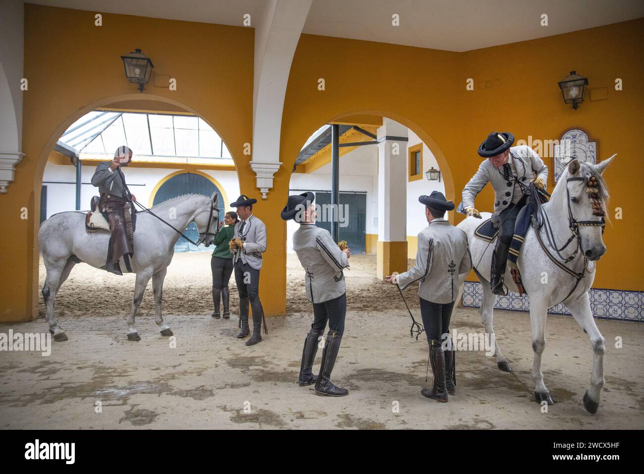 Spain, Andalusia, Jerez de la Frontera, Andalusian royal school of equestrian art, riders in Goyesque costume on their white horses in the vaulted stables Stock Photo