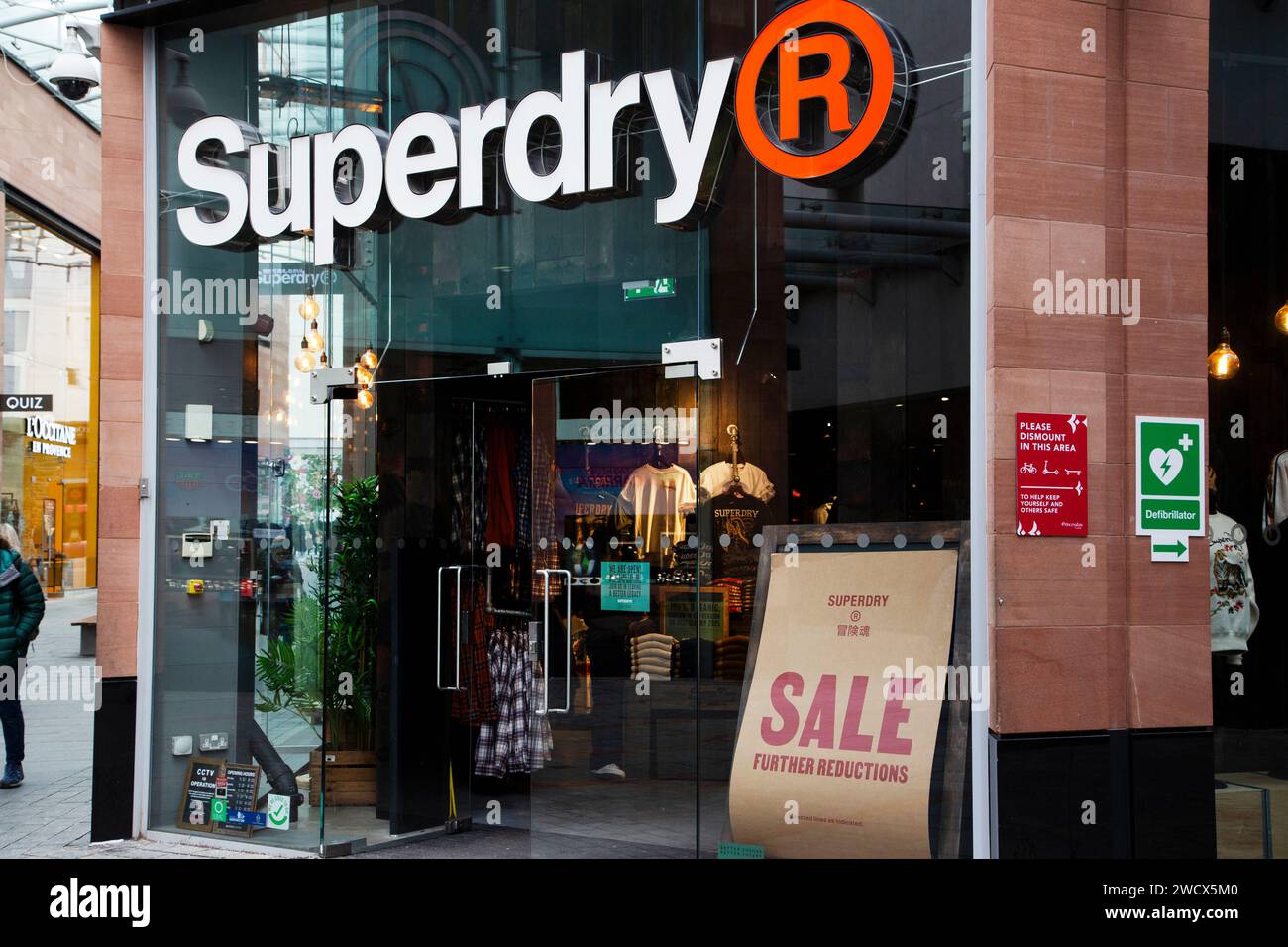 January brown and red paper sale sign in Superdry shop front window at Princesshay, Exeter UK Stock Photo