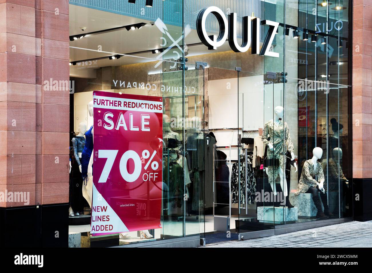 January sales 70% off red discount sign on Quiz shop front window in Exeter UK Stock Photo