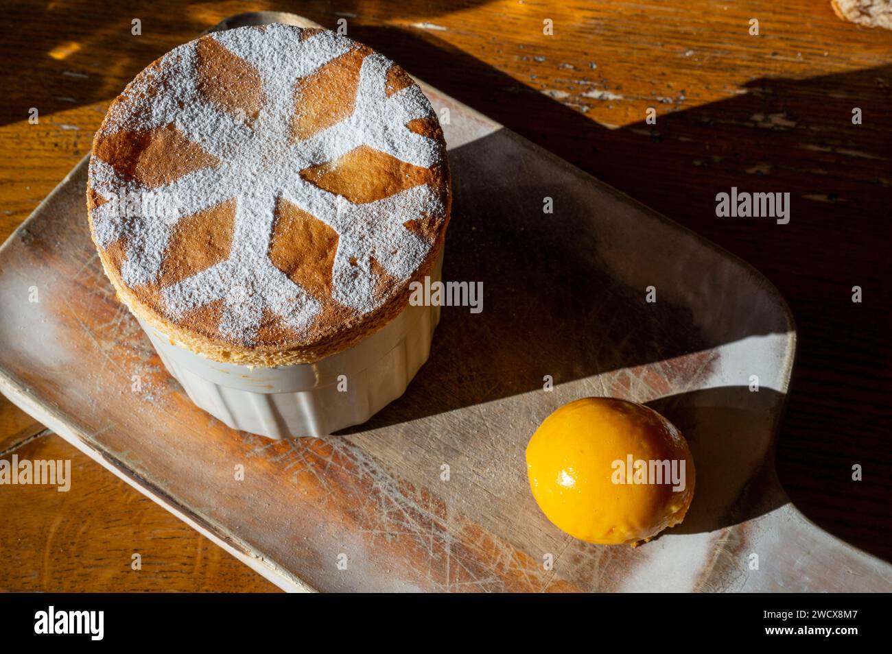 France, Haute Savoie, Megeve, restaurant Le Refuge, very cozy interior, a dessert dish with a drawn snowflake : hot soufflé with grand Marnier Stock Photo