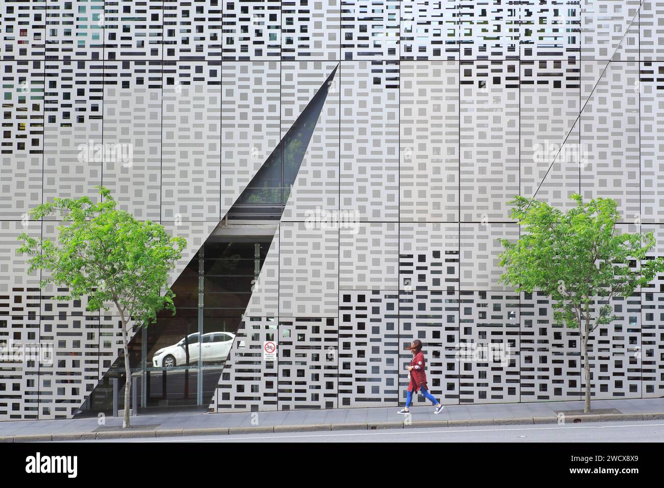 Australia, New South Wales, Sydney, Broadway, UTS (University of Technology) Broadway Building, Faculty of Engineering and IT Building (Building 11) by the architectural firm Denton Corker Marshall, pedestrian walking along the building Stock Photo