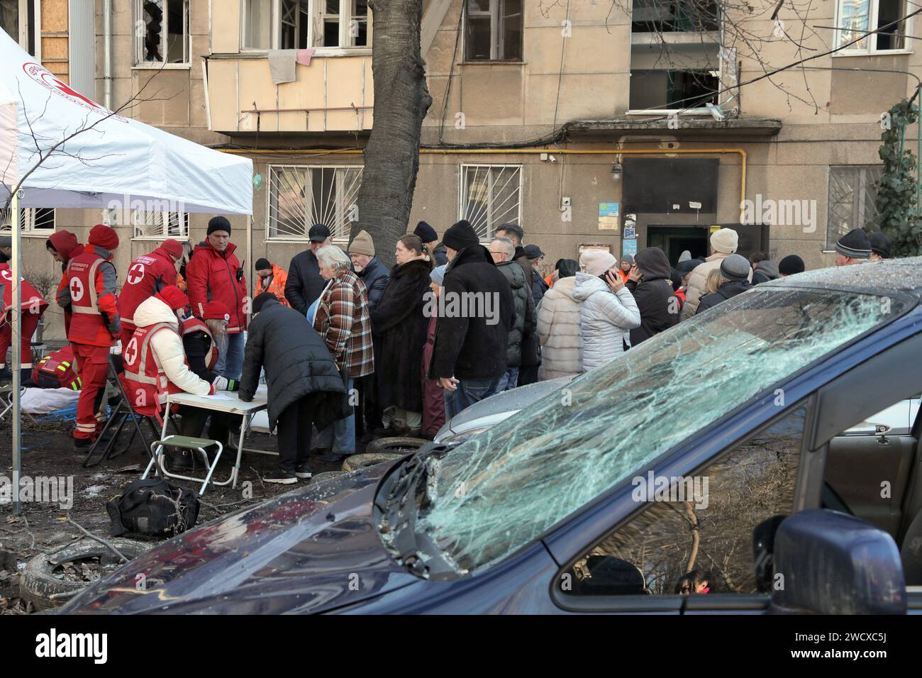 ODESA, UKRAINE - JANUARUY 17, 2024 - Volunteers of the Rapid Response Unit of the Ukrainian Red Cross distribute humanitarian aid (window film, food, etc.) to residents of a house damaged by a night attack of Russian drones on Odesa, Odesa, southern Ukraine. Stock Photo