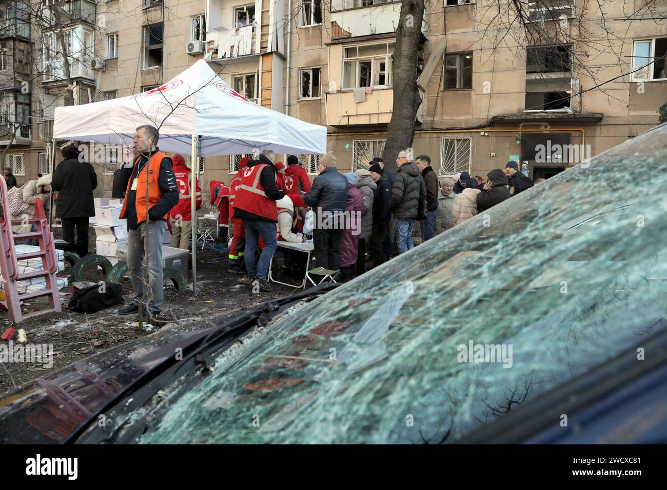 ODESA, UKRAINE - JANUARUY 17, 2024 - Volunteers of the Rapid Response Unit of the Ukrainian Red Cross distribute humanitarian aid (window film, food, etc.) to residents of a house damaged by a night attack of Russian drones on Odesa, Odesa, southern Ukraine. Stock Photo