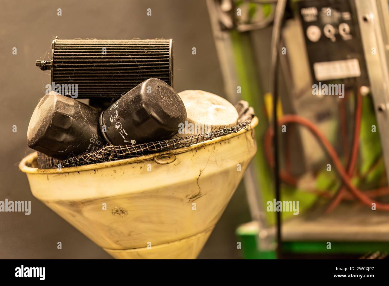 Photo of old, exhausted oil filters in a symbolizing hazardous waste disposal in