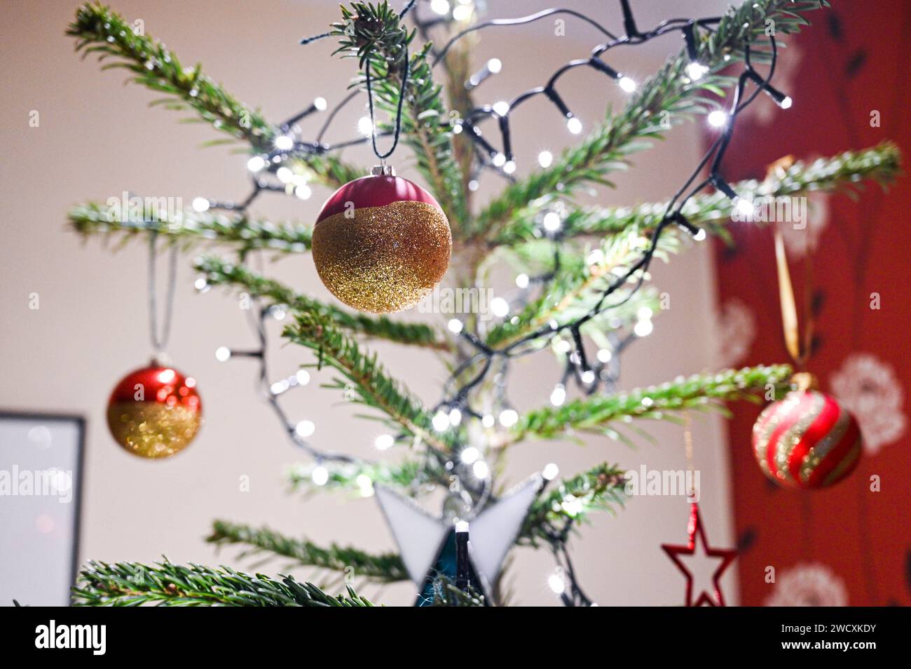 Christmas tree decorations with baubles and lights UK Stock Photo