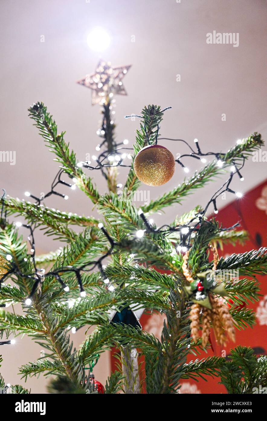 Christmas tree decorations with baubles and lights UK Stock Photo