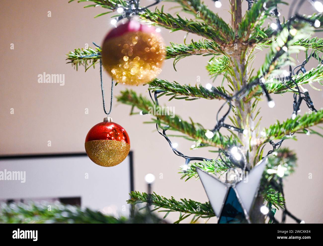Christmas tree decorations with baubles and lights UK Stock Photo