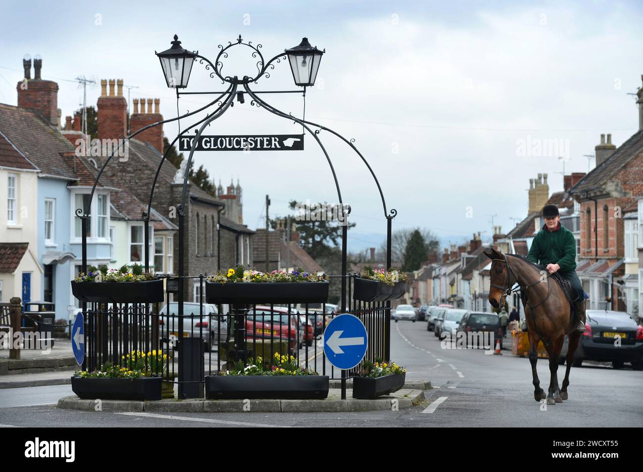 Horse riders pass the 'Pump & Canopy' landmark in Thornbury in South