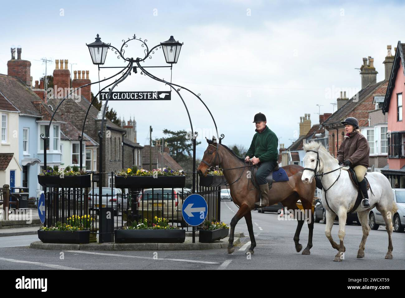 Horse riders pass the 'Pump & Canopy' landmark in Thornbury in South