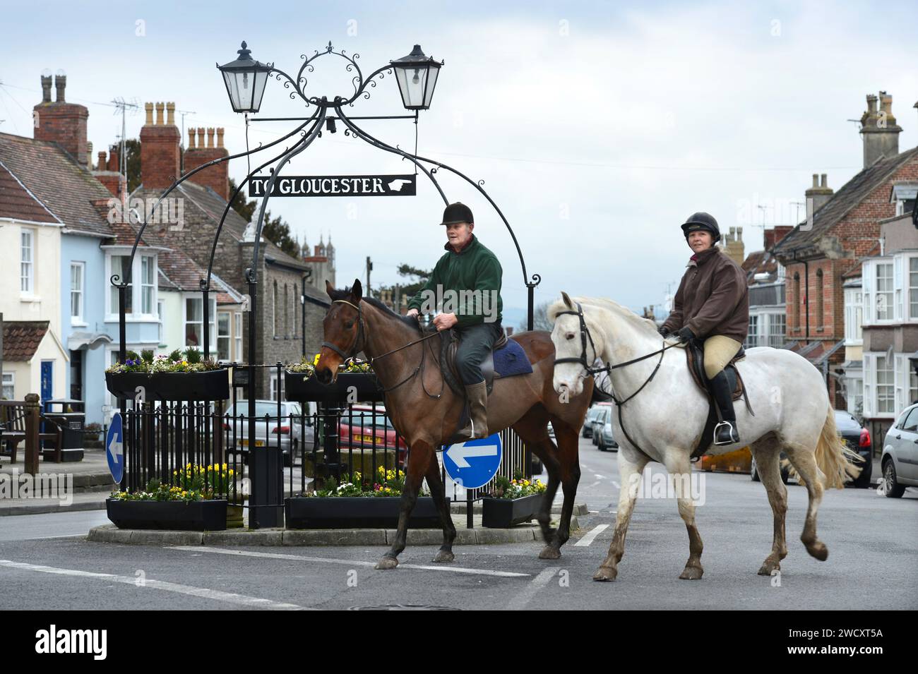 Horse riders pass the 'Pump & Canopy' landmark in Thornbury in South