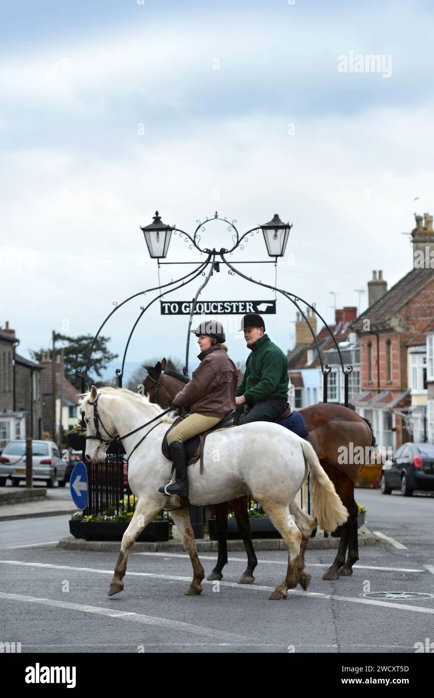 Horse riders pass the 'Pump & Canopy' landmark in Thornbury in South